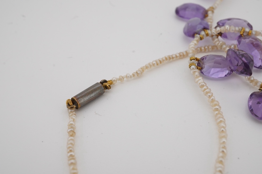 An early 20th century seed pearl and graduated oval cut amethyst set fringe necklace, 36cm. Condition - fair to good